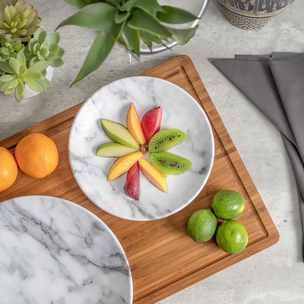 Merritt Designs White Marble 8.5 inch melamine salad plate with a selection of sliced fruit
