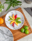 Merritt Designs White Marble 8.5 inch melamine salad plate with a selection of sliced fruit