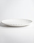 Cream colored, 11-inch melamine dinner plate with beaded rim, front view