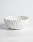 Cream colored, 6-inch round melamine salad bowl with beaded rim, front view