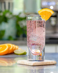 Merritt Designs Teardrop Rainbow 5oz Acrylic Tumbler with sparkling drinks and orange garnish