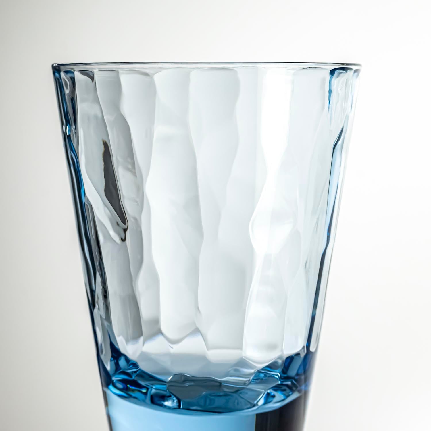 4-ounce blue acrylic tumbler glass from the Merritt Designs Cascade collection. Detailed view on white background