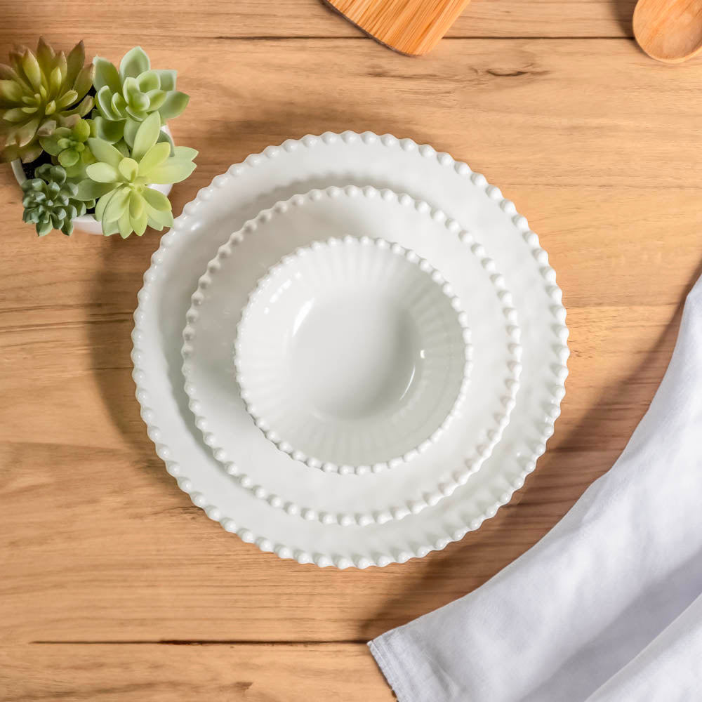 Merritt Designs Beaded Pearl 11 inch Melamine Dinner Plate Set Cream stacked with salad bowl and salad plate on medium wood tabletop